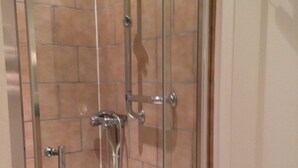 A glass-enclosed shower with a tiled wall, a handheld showerhead, and a handheld shower control. - Charming home in Champagne Vineyards Near sezanne (Broyes)