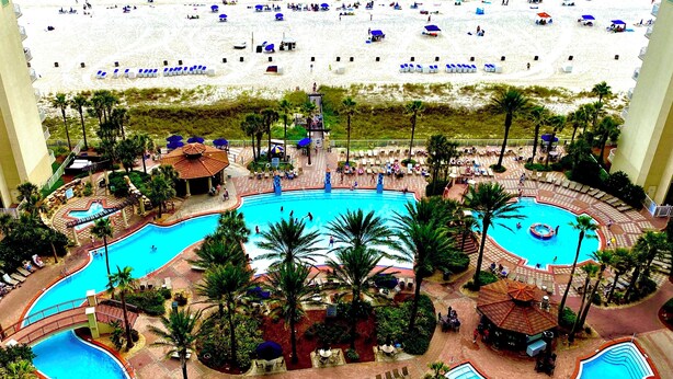 A resort with a large pool, beach, and palm trees. - 🌴 Rare Double Gulf View~Free Beach Chairs~No Resort Fee~2nd floor Front Parking (Panama City Beach)