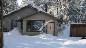 A small, single-story cabin with a sloped roof, surrounded by snow-covered ground and trees. - Spa, Quiet, Peaceful Near Rollins Lake, Local Hiking, Romantic, Reunion, Retreat (Gold Run)