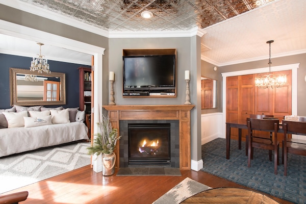 Gas fireplace in living room with dining room to right and library to left.