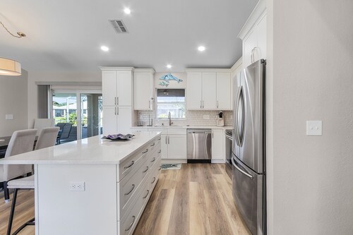 Peaceful fresh water canal home with heated pool. Incredible Value.