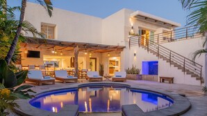 A modern house with a swimming pool, outdoor seating, and a staircase leading to a second floor. - Villa Luna Nueva - Concierge and Maid Service included (Cabo San Lucas)