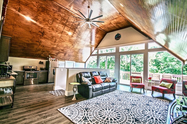 Wall of windows with double sliding door access to deck