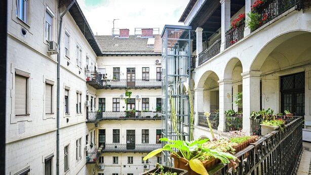 A multi-story building with balconies, some with plants and flowers. - Large 3BR/3BA Flat Next to Central Market | Free Parking (Budapest)