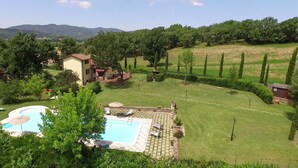 Il s’agit d’une propriété résidentielle dotée d’une piscine, d’une pelouse bien entretenue et offrant une vue sur les collines environnantes.