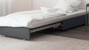 A single bed with a grey frame and white bedding, a bedside table, and a floor lamp. - The ancient alley, just a step away from everything (Salerno)