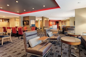 Relax in comfort with sofas, armchairs, and tables, plus TVs and a reception desk.