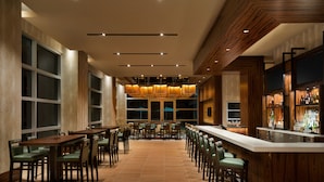 A spacious restaurant with high ceilings, large windows, and a central bar area. - The Landing Hotel at Rivers Casino Schenectady (Schenectady)