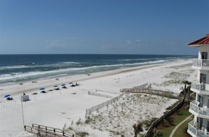 A beach view with a wooden boardwalk, a white building with balconies, and a date stamp of 10/15/2008. - Absolute Gulf Front! Upscale Decorated, Low-Rise Condo with 10/10 Star Rating! (Orange Beach)
