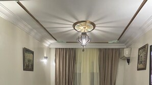 A living room with a sectional sofa, a round coffee table, and a chandelier. - BEAUTIFUL APARTMENT CASA FURNITURE. Luxury building (casablanca)
