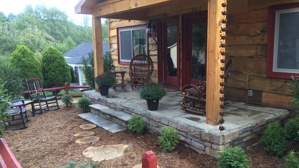 A wooden cabin with a porch, stone steps, and outdoor seating. - Downtown Main Street "STONES" FENCED YARD (Blowing Rock)