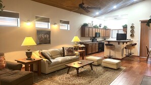 A living room with a sofa, coffee table, and ottoman, a kitchen with wooden cabinets, and a ceiling fan. -  Pinetop Lakes CClub, One Level, AC, Private, Gated, Close To Amenities! (Pinetop)