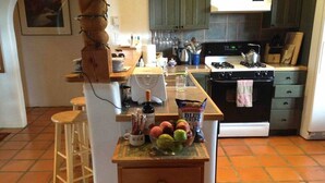 A kitchen with a central island, a stove, and a sink.