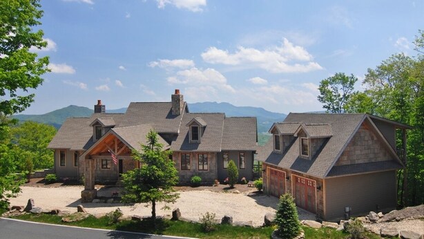 A large, multi-story house with a stone facade, multiple chimneys, and a well-maintained lawn. - Multi-Million Dollar Mountain Estate-FOUR STATE VIEWS (Banner Elk)