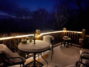 Enjoy a peaceful evening on the deck, surrounded by serene darkness.
