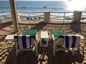 On the beach, sun loungers, beach towels