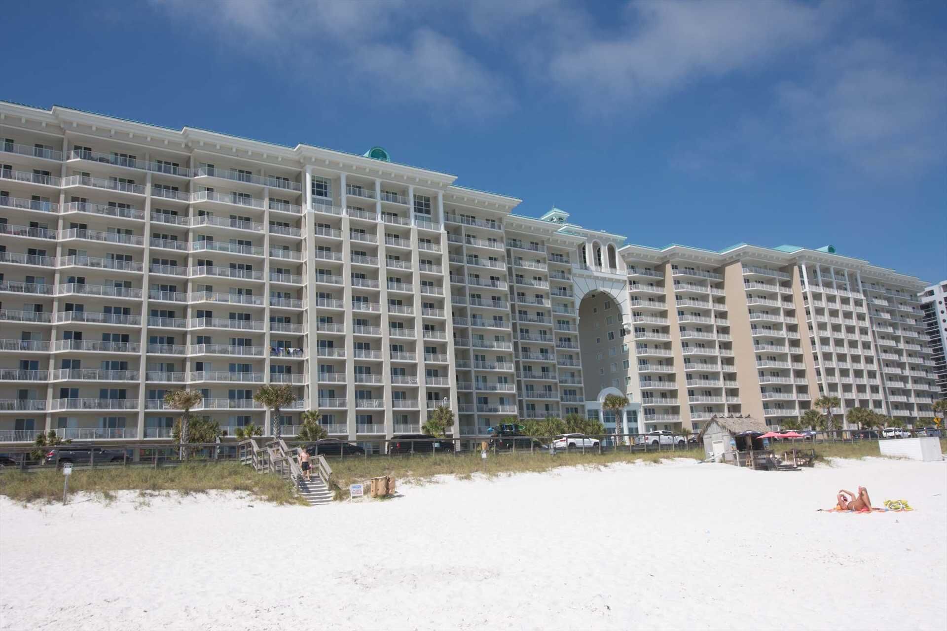 A large hotel with multiple floors, balconies, and a central archway.