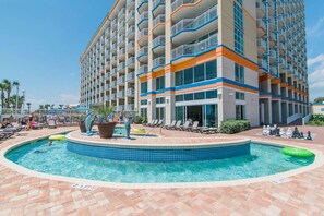 A hotel with a pool area, including a circular pool and lounge chairs. - 3BR/2BA Dunes Village, Indoor Waterpark, 8th Floor (Myrtle Beach)