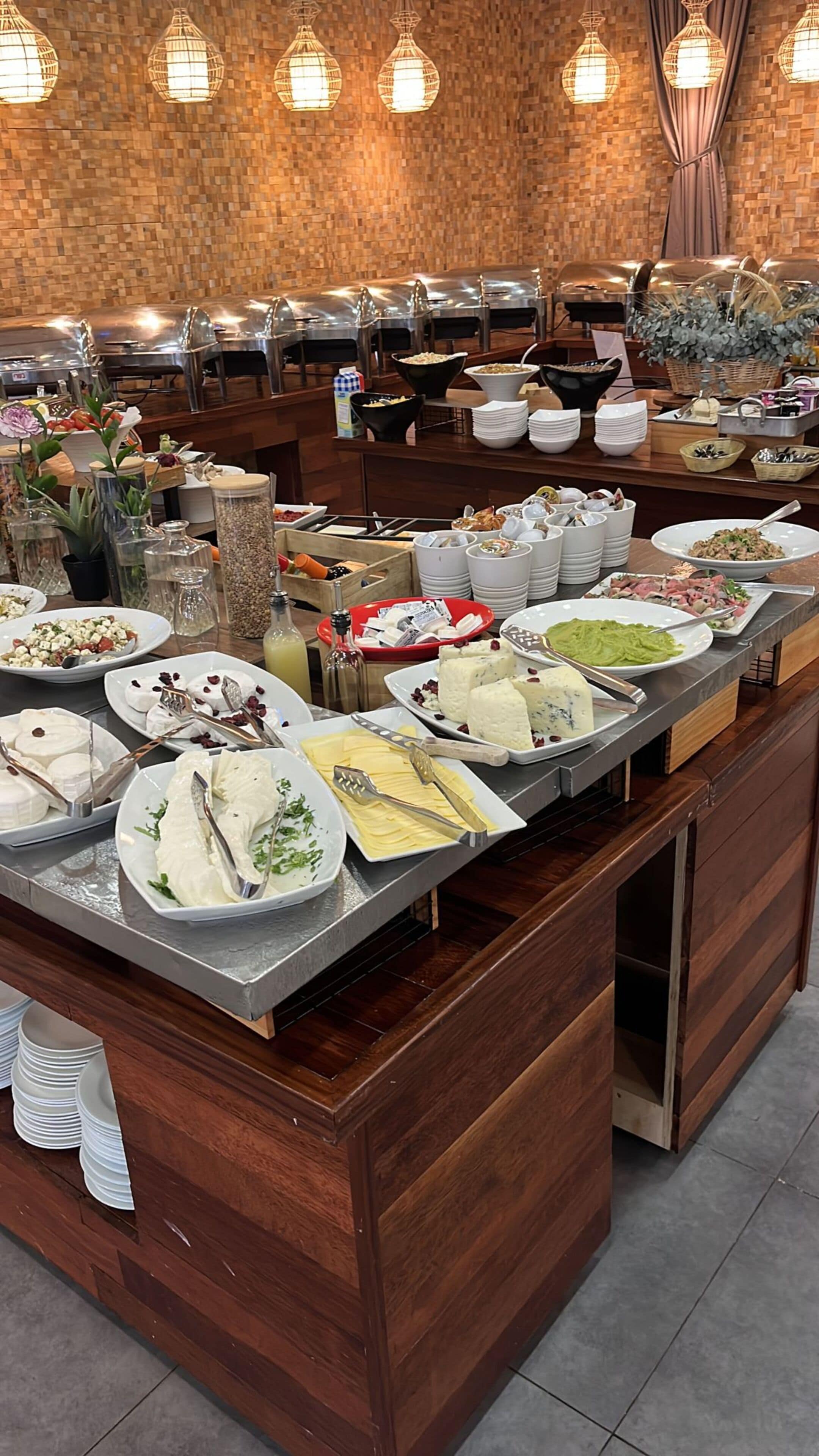 A buffet setup with various food items and utensils.