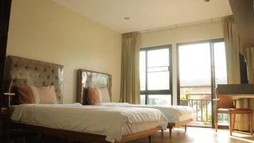 A hotel room with two beds, a balcony, and a piano.