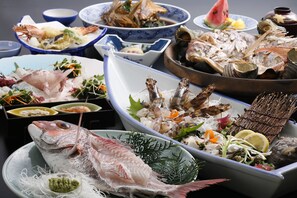 A variety of seafood dishes displayed on a table. - Awaji Island Uzushio Onsen Umemaru (Minamiawaji)