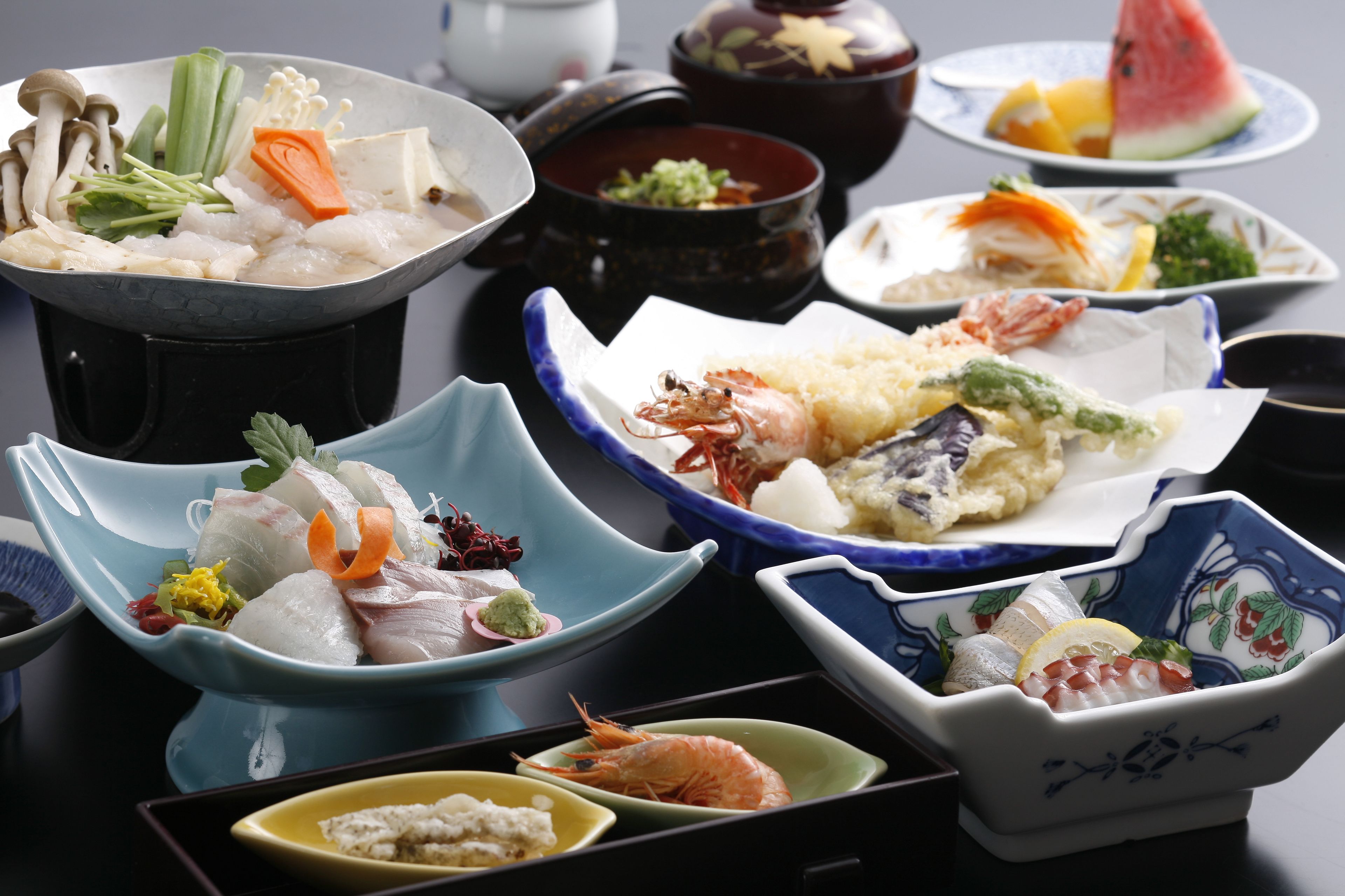 A variety of dishes in traditional bowls, including seafood and vegetables. - Awaji Island Uzushio Onsen Umemaru (Minamiawaji)