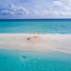 On the beach, white sand, sun loungers, beach towels