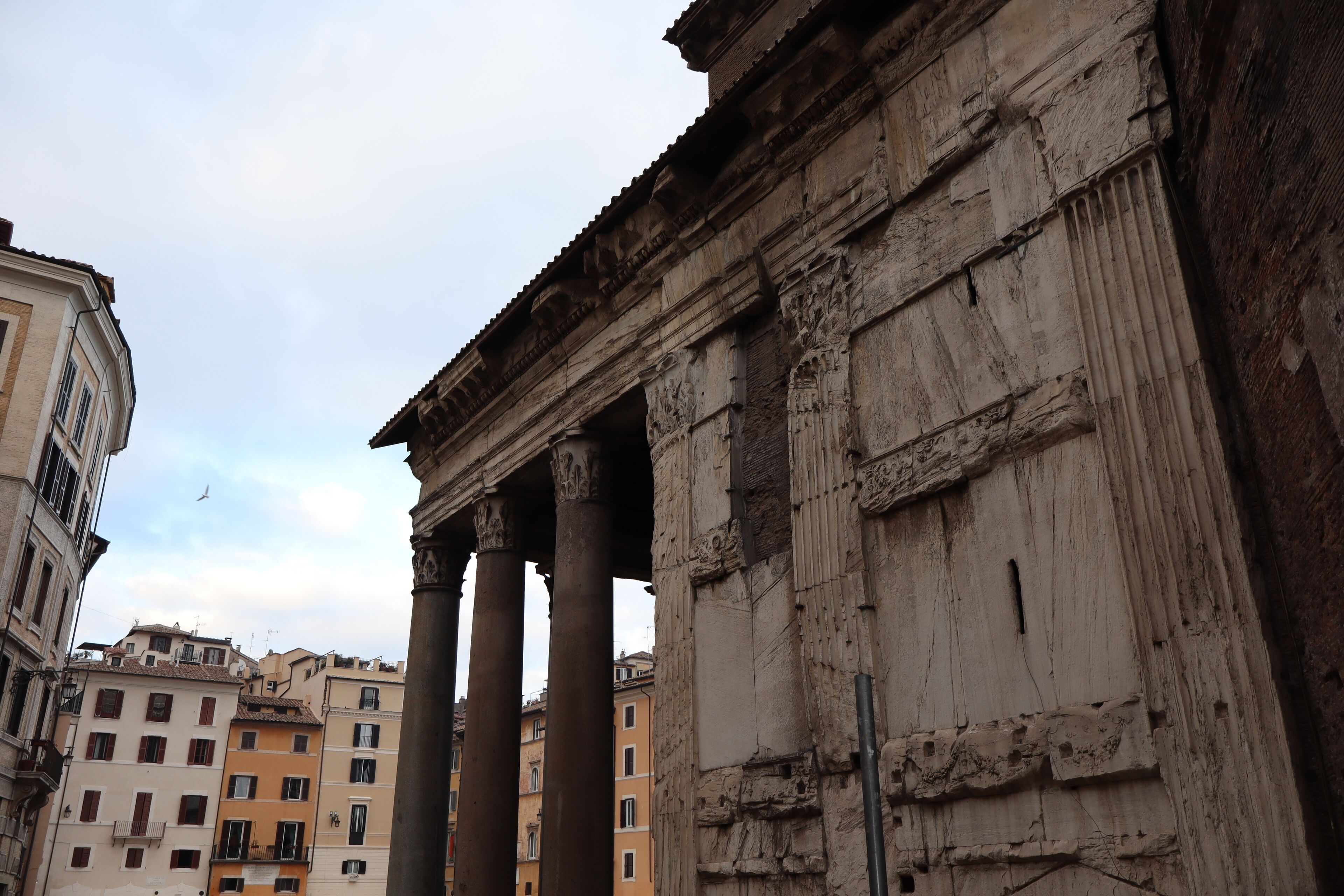 A historic building with classical columns and detailed stonework.