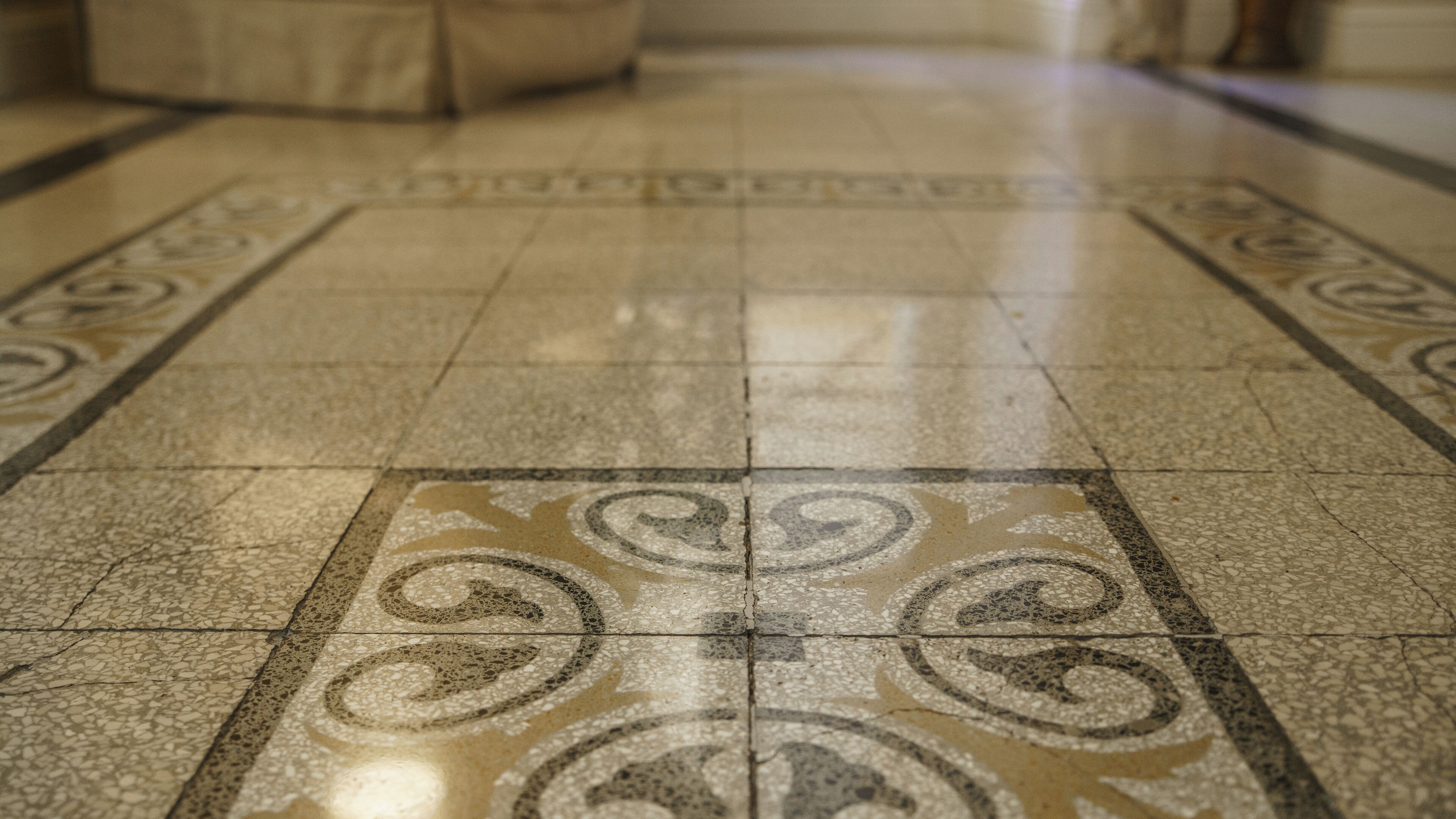 A close-up of a tiled floor with a decorative pattern.