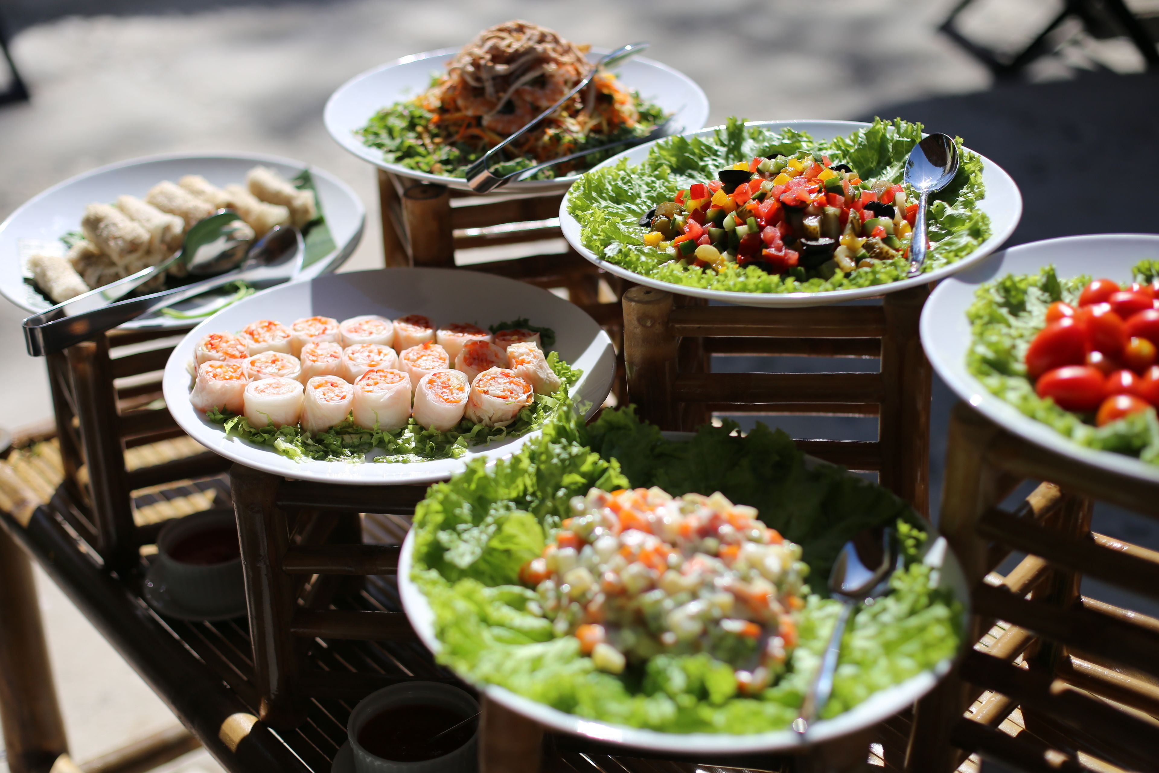 A variety of food dishes arranged on a table with a metal rack.