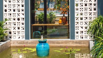Stunning water feature surrounded by lush plants and flowers, creating a serene atmosphere.