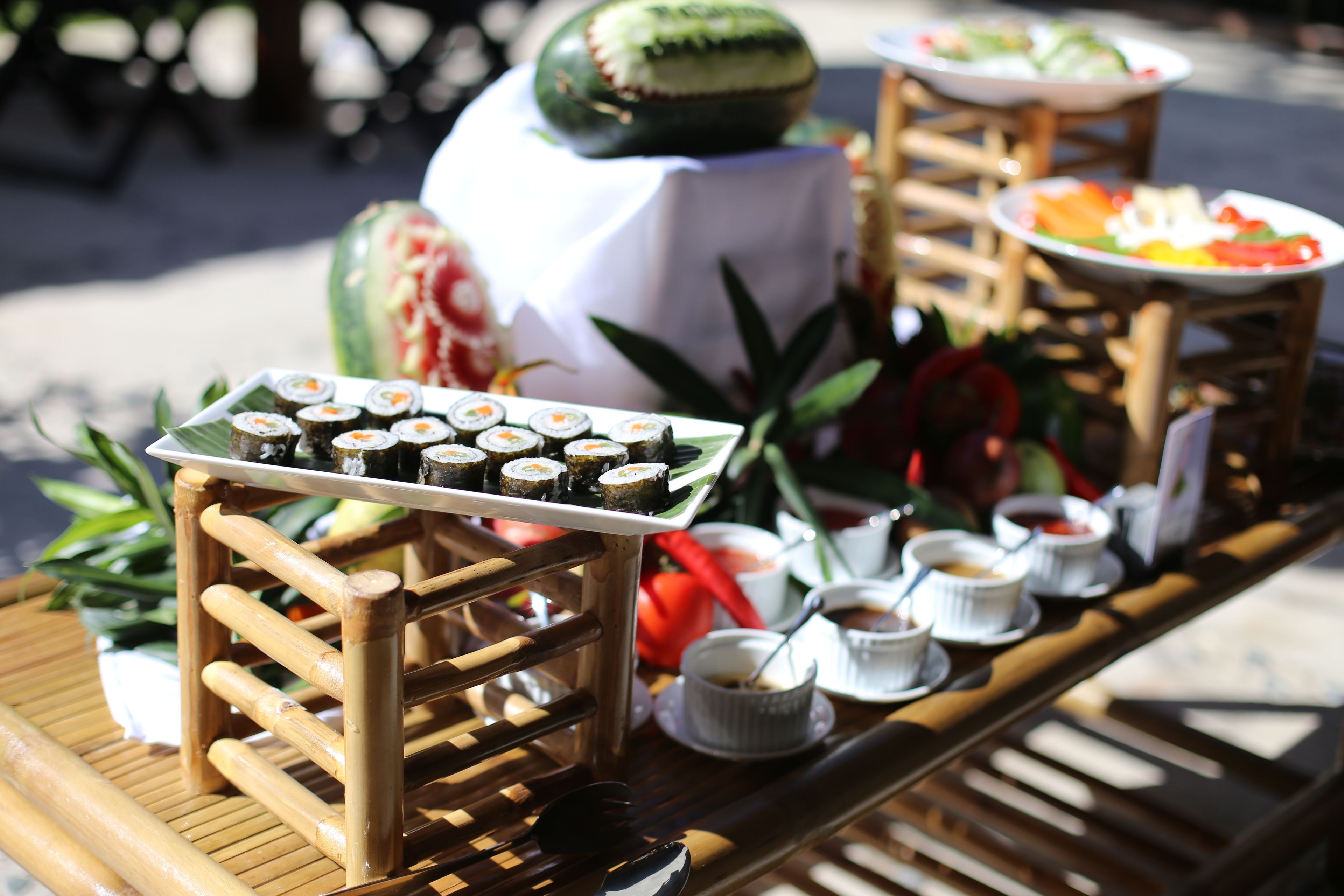 A buffet table with various food items and a decorative centerpiece.