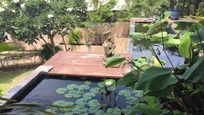 A serene garden with a pond, a wooden deck, and a statue. - 4 Bedroom 300 degrees Sea View Villa SDV139A-By Samui Dream Villas (Koh Samui)