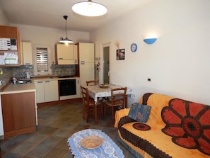 Apartment, 2 Bedrooms (Il Castello 1) | Living area | Flat-screen TV