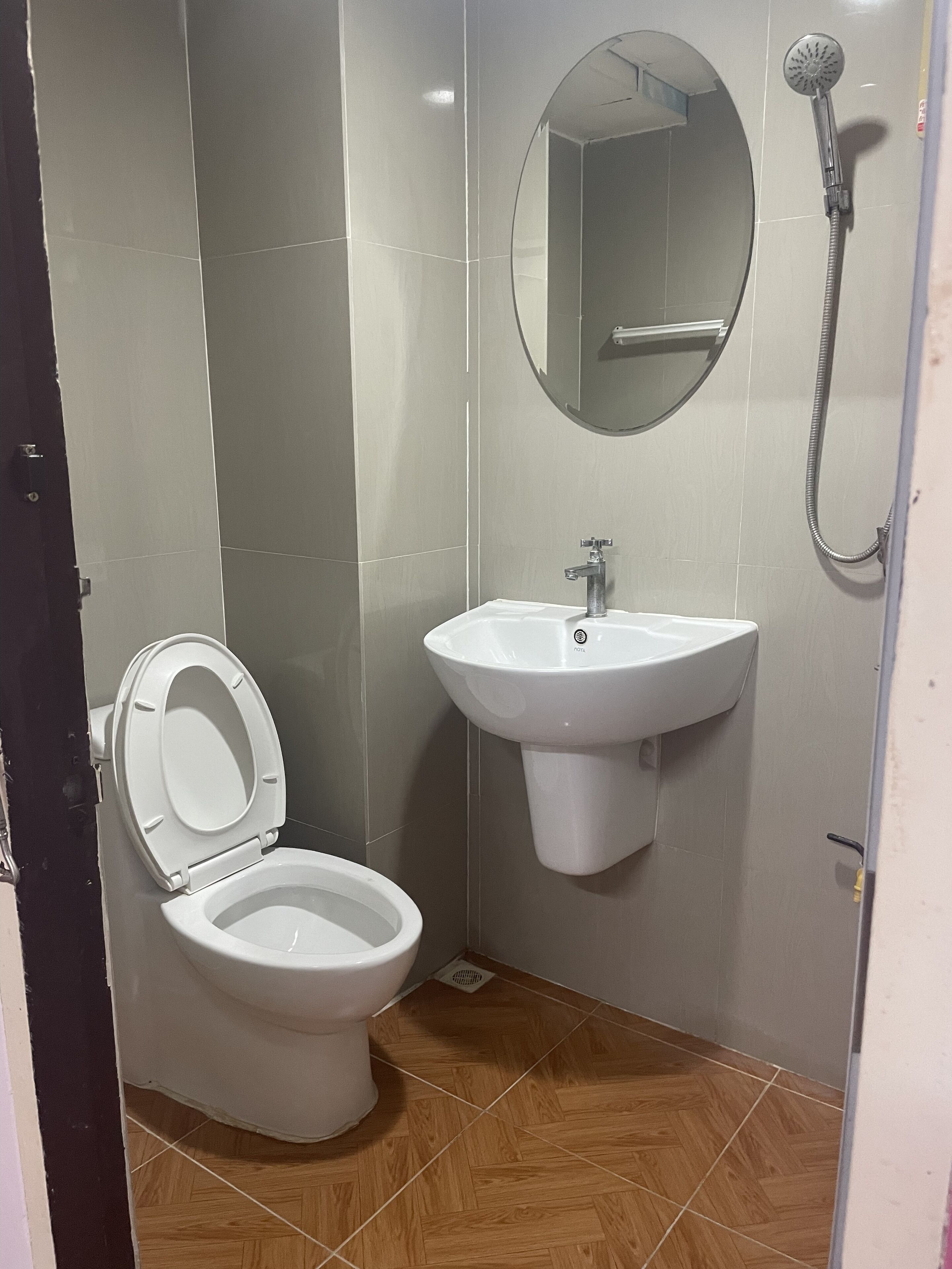 A bathroom with a toilet, sink, and shower.