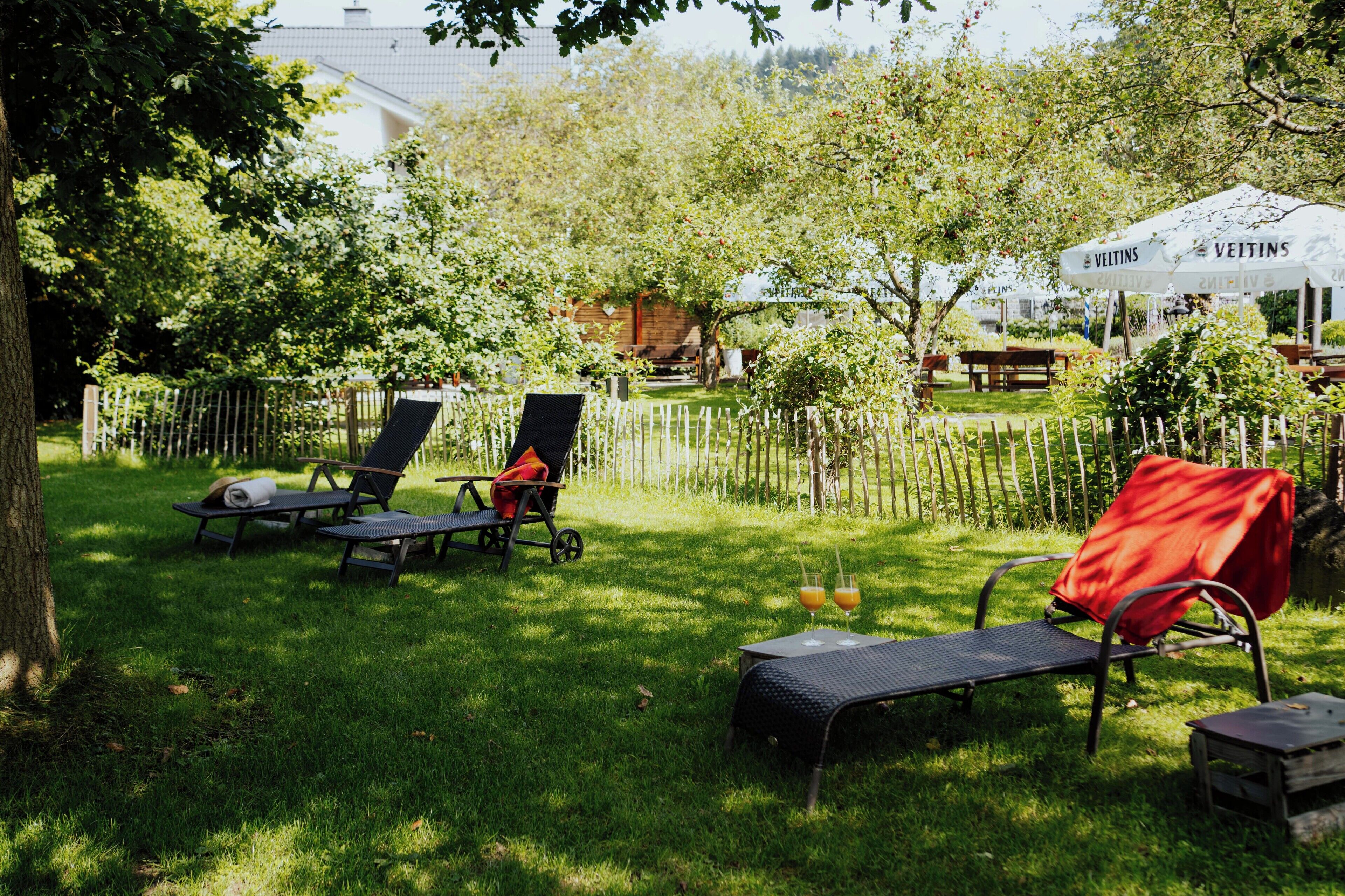 A backyard with outdoor furniture, a tent, and a fence.