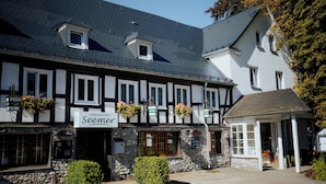 Een traditioneel vakwerkhuis met een bord voor restaurant 'Seemer'.