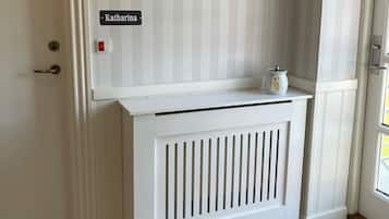 A white door with a nameplate reading "Katharina" and a small white radiator below it.