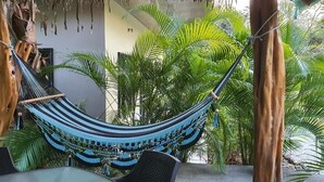 A hammock between trees in a tropical setting. - Aloha Surf Nosara (Nosara)