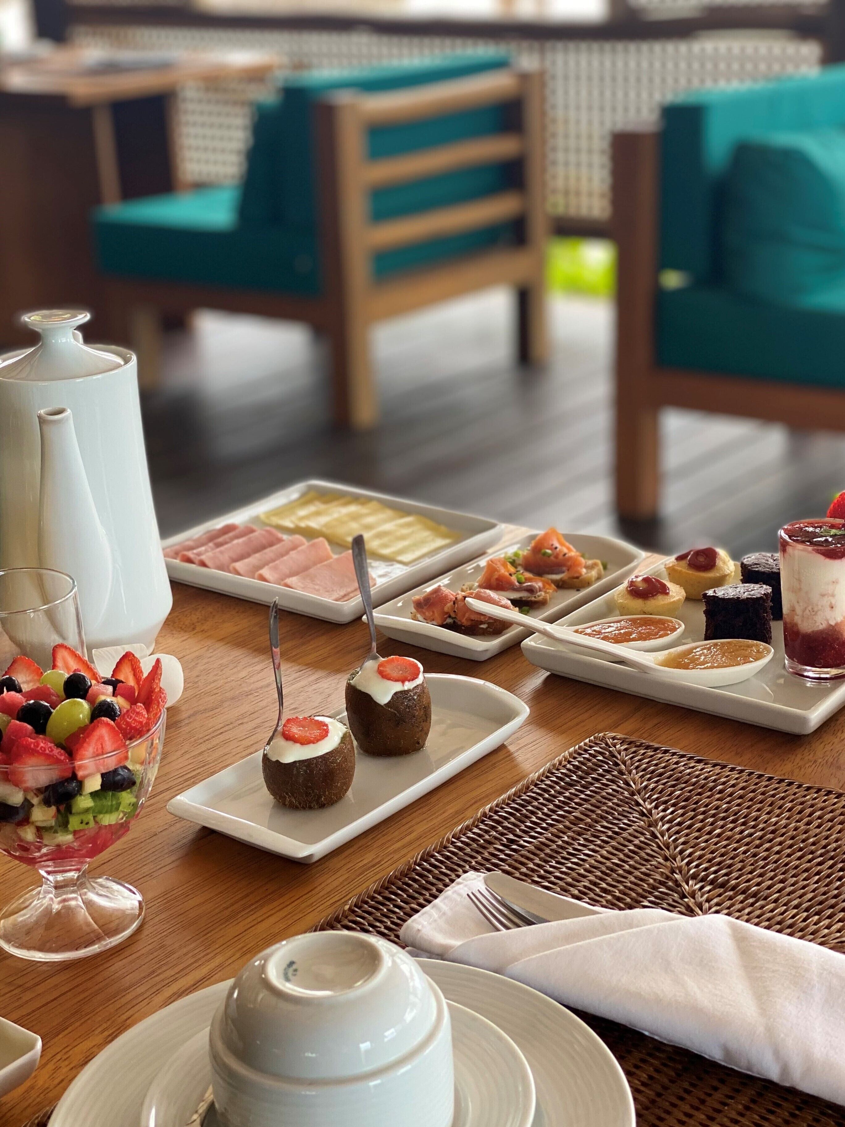A breakfast buffet with various dishes and a coffee pot.