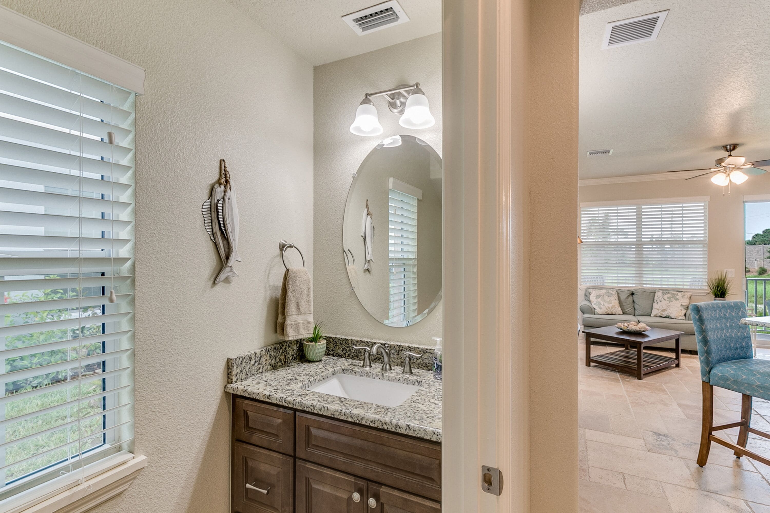 A bathroom with a sink, mirror, and towel rack.
