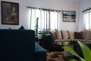 Deluxe Room, 2 Bedrooms, Pool Access, Garden View | Living room | 50-inch flat-screen TV with cable channels, TV, DVD player - The Country Club Villa I (Kingston)