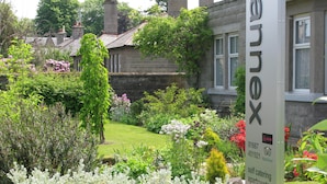 A sign for "The Jox" indicating self-catering apartments with a garden view.