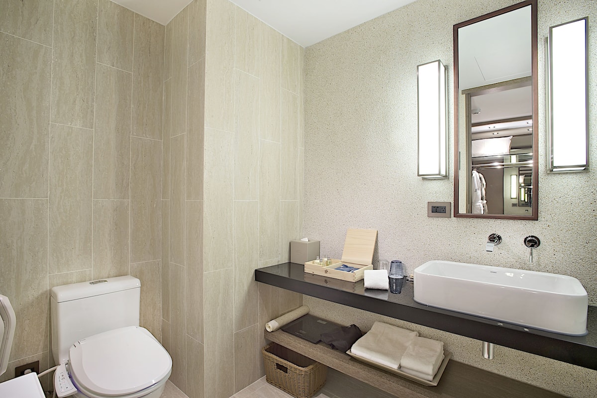designer toiletries, hair dryer, bathrobes, slippers