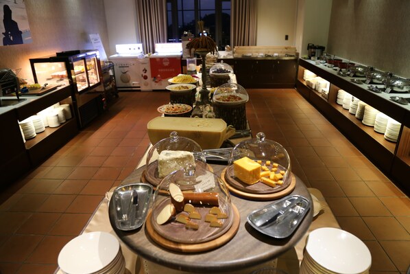 A buffet setup with various food items and dishes displayed on tables. - The Gaya Hotel (Taitung)