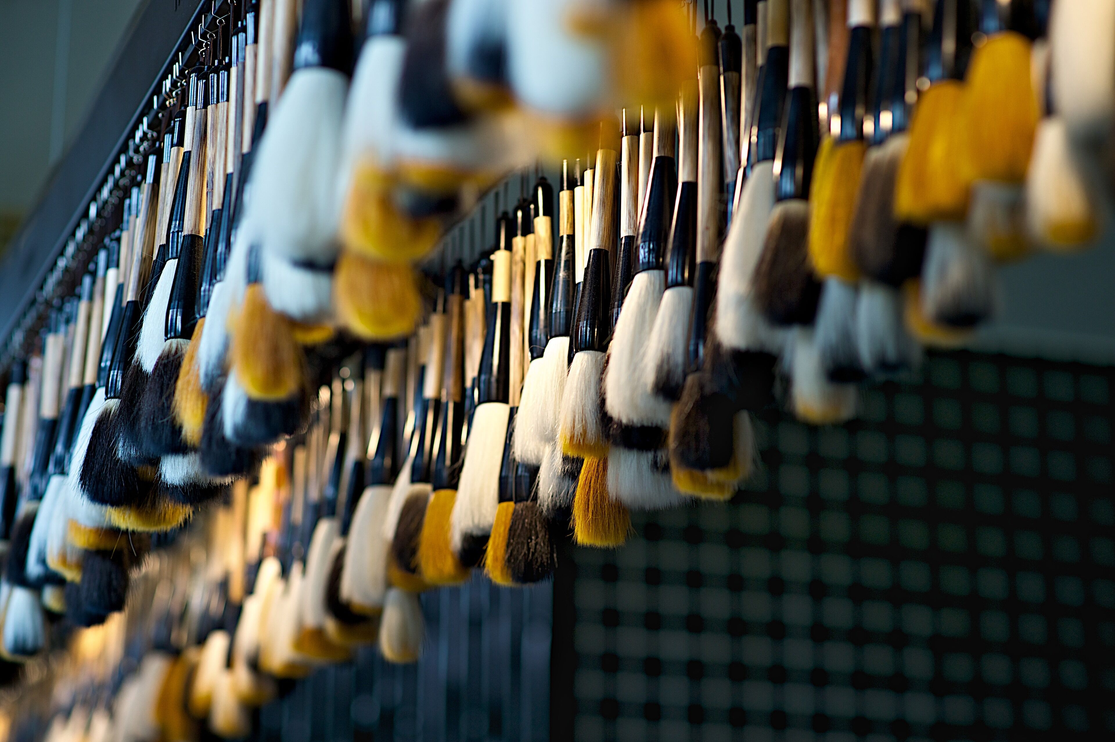 A collection of tools hanging on a wall.