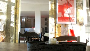 A rustic interior with stone walls, a wooden table, and a framed poster on the wall. - 17th century character house in village center with swimming pool (Saint-Laurent-D'aigouze)