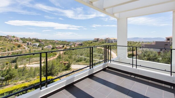 A balcony with a view of a hilly landscape and distant buildings. - Mountain maissonette in Athens with breathtaking views.  (Athens)
