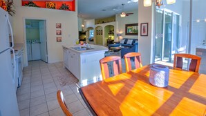 A spacious kitchen with a dining area, a built-in oven, and a large island with a sink. - Orlando Comfort, Splash and FUN in Windsor Palms Resort - Disney next door (Kissimmee)