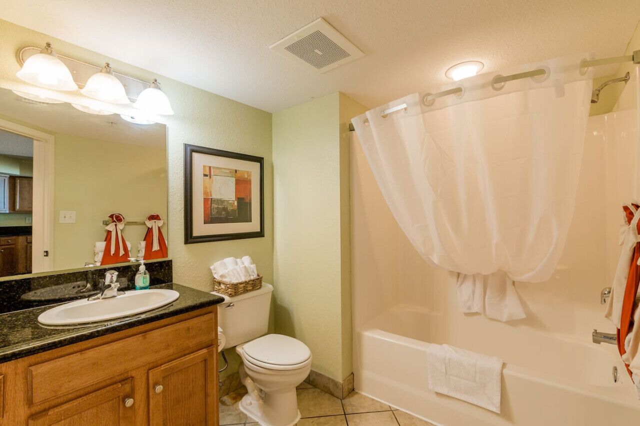 A bathroom with a sink, toilet, and bathtub.